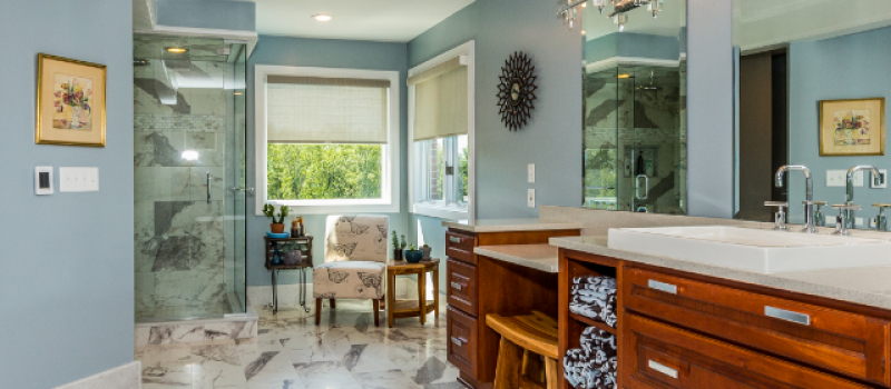 A bathroom with marble floors and walls.